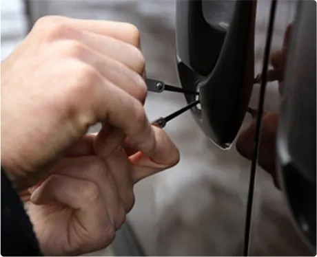 Auto locksmith unlocking a car door in Queens