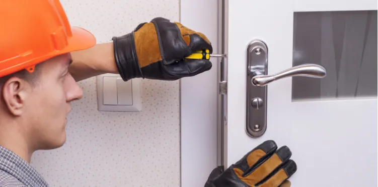 Locksmith installing a new door lock in Queens