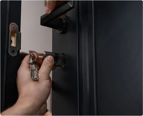 Residential locksmith installing a front door lock in Queens
